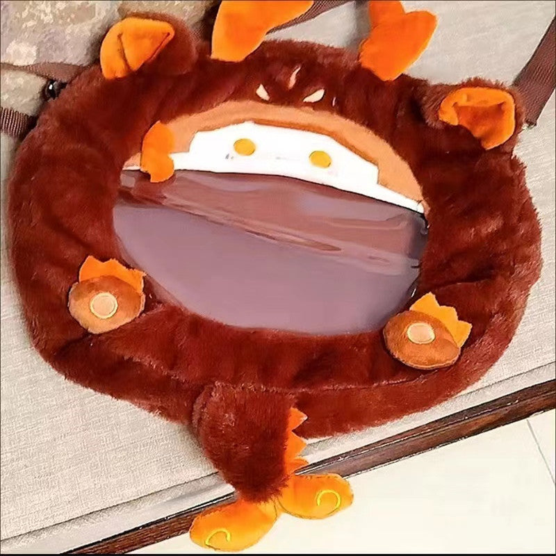 Brown plush dragon bag top view, zipper closure and orange paw appliqués
