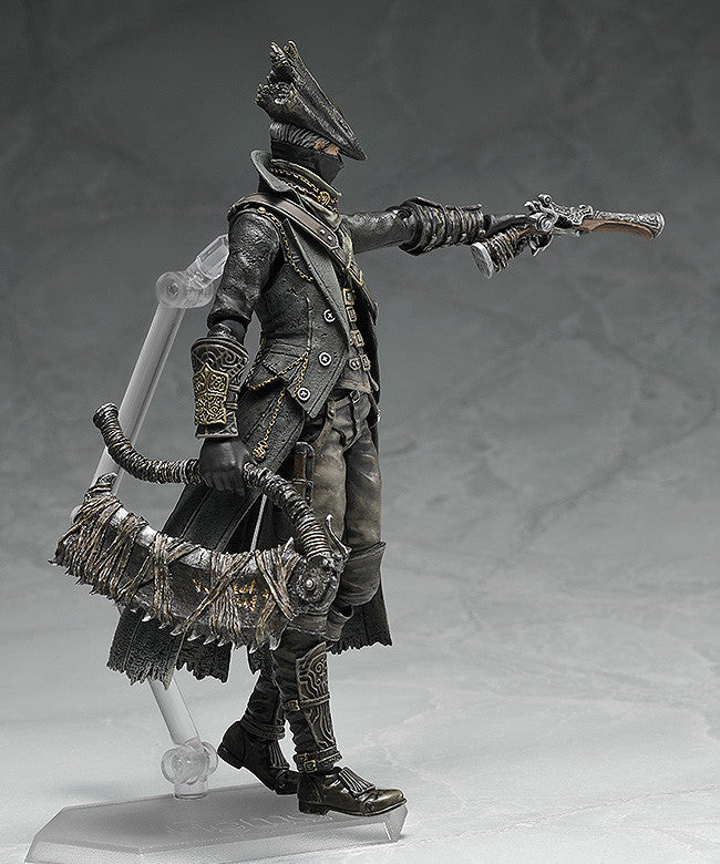 Black hunter action figure holding large blade, long coat with layered cape and boots