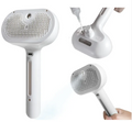 Pet Hair Spray Brush, white with pin bristle pad and spray nozzle on handle.