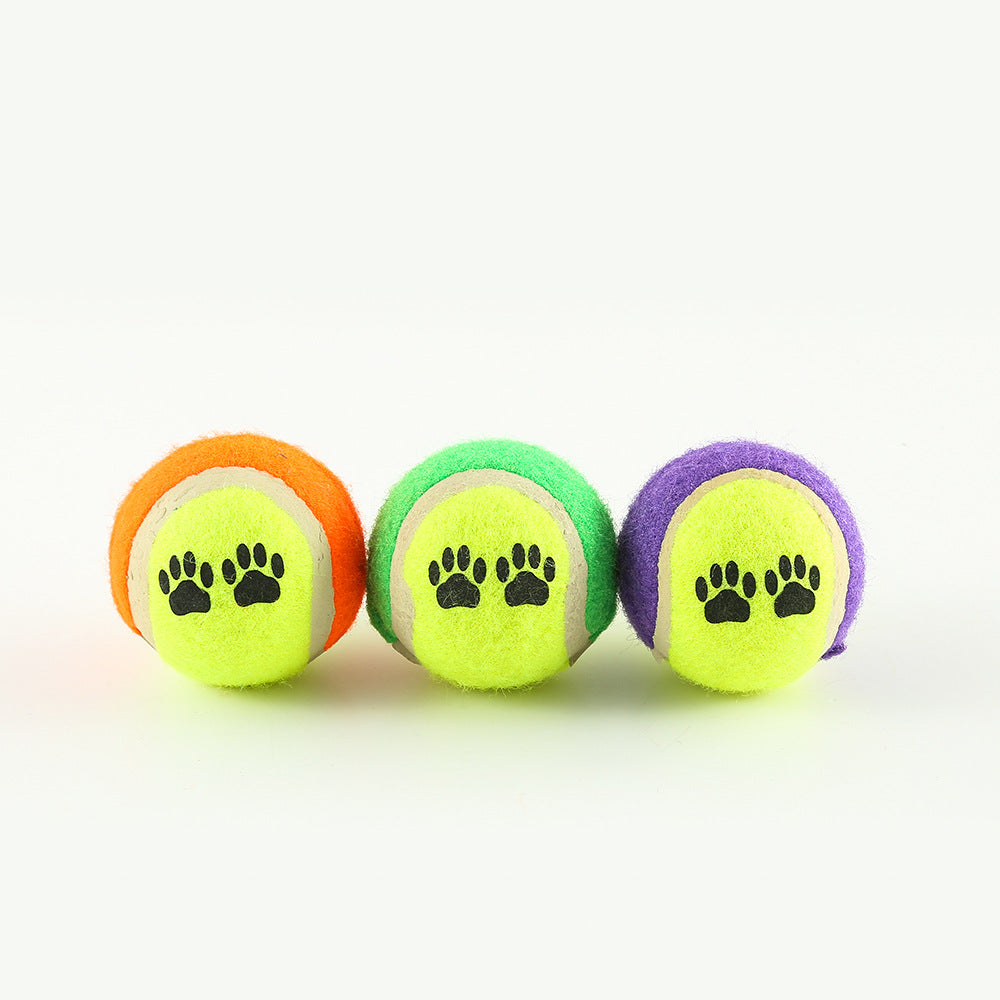 Three paw-print balls for fetch trainer in orange, green, and purple