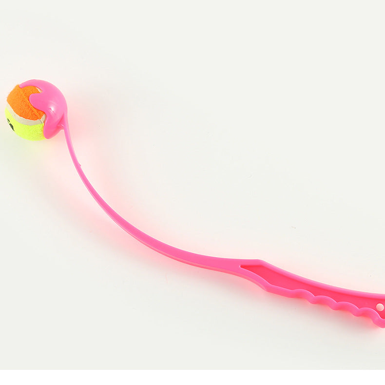 Pink dog fetch launcher with orange-and-yellow ball and textured grip handle