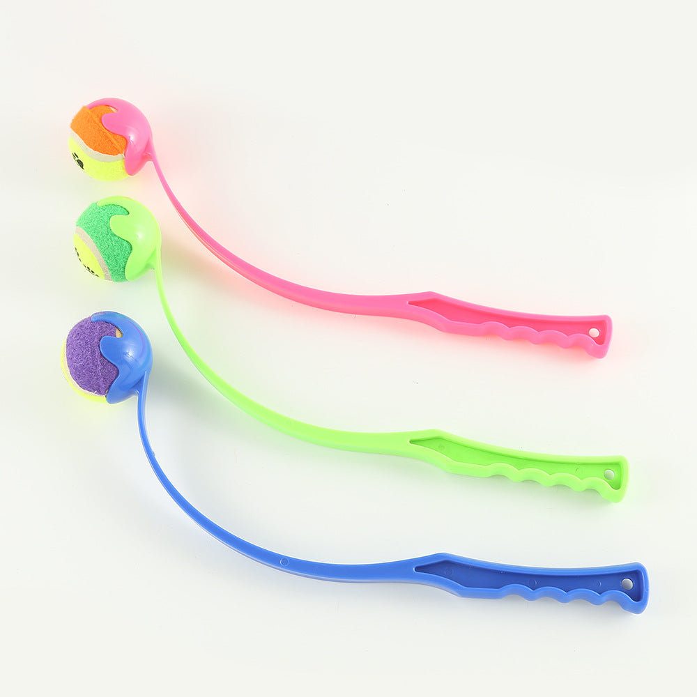 Outdoor dog ball launcher set with pink, green, and blue handles and paw balls