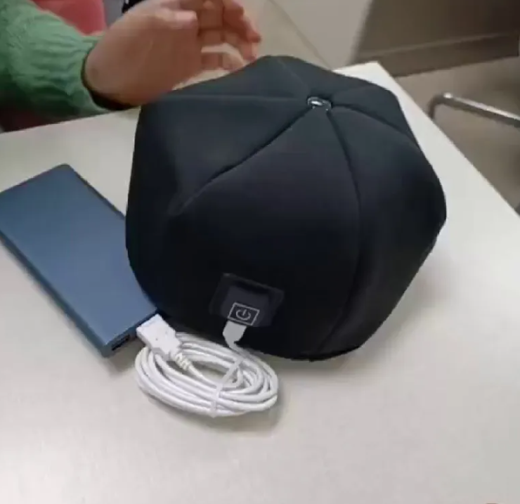 Black hair rejuvenation helmet with power adapter and coiled cable