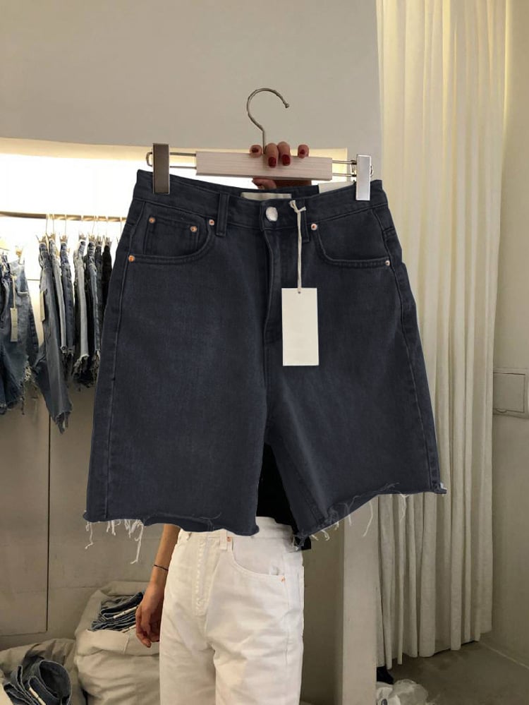 Black five-point denim shorts, loose cut, frayed edges, button closure, visible back pockets.