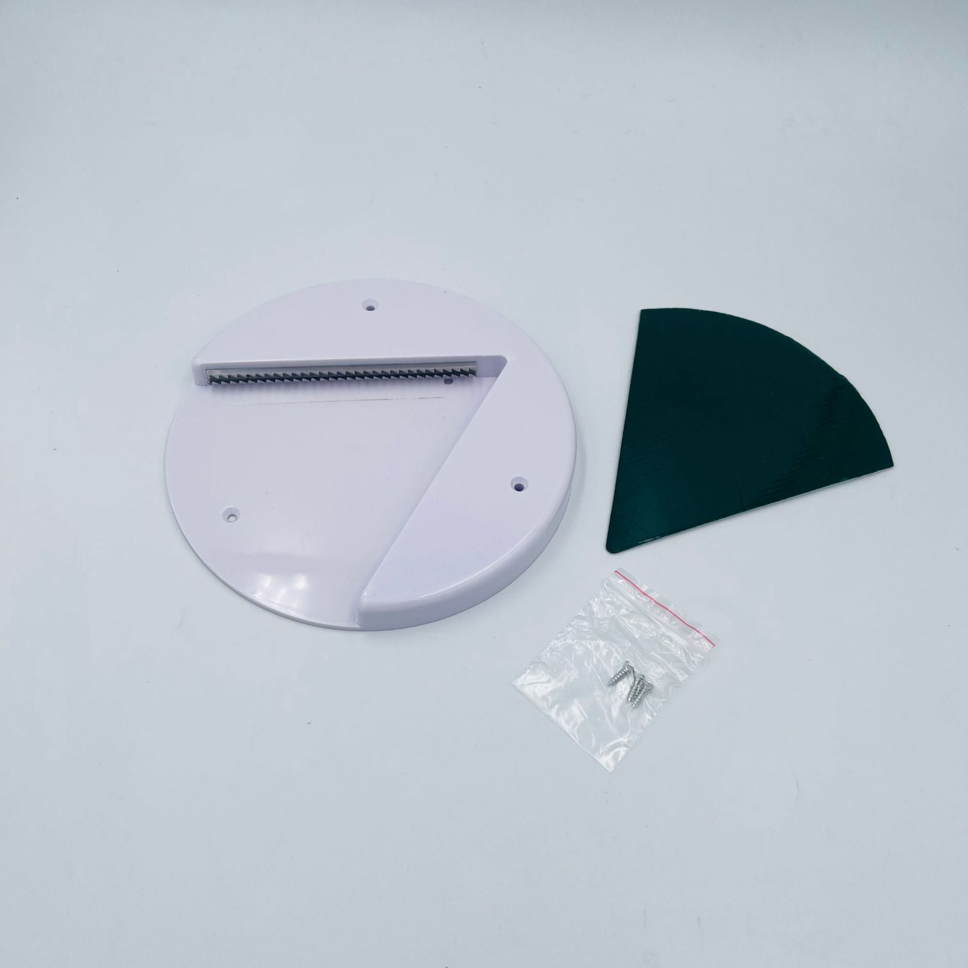 Universal jar and bottle opener with white circular base, serrated blade, green insert