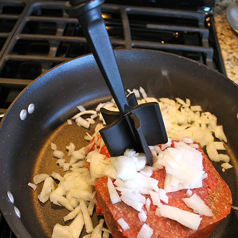 Meat Masher & Mixing Stick mashing food in a skillet with black mash head