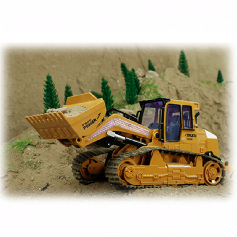 Yellow RC bulldozer excavator toy with front scoop and operator cab