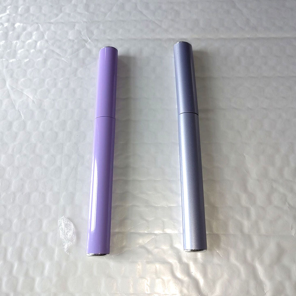 Purple and silver electric eyelash curlers with slim heated barrel shapes