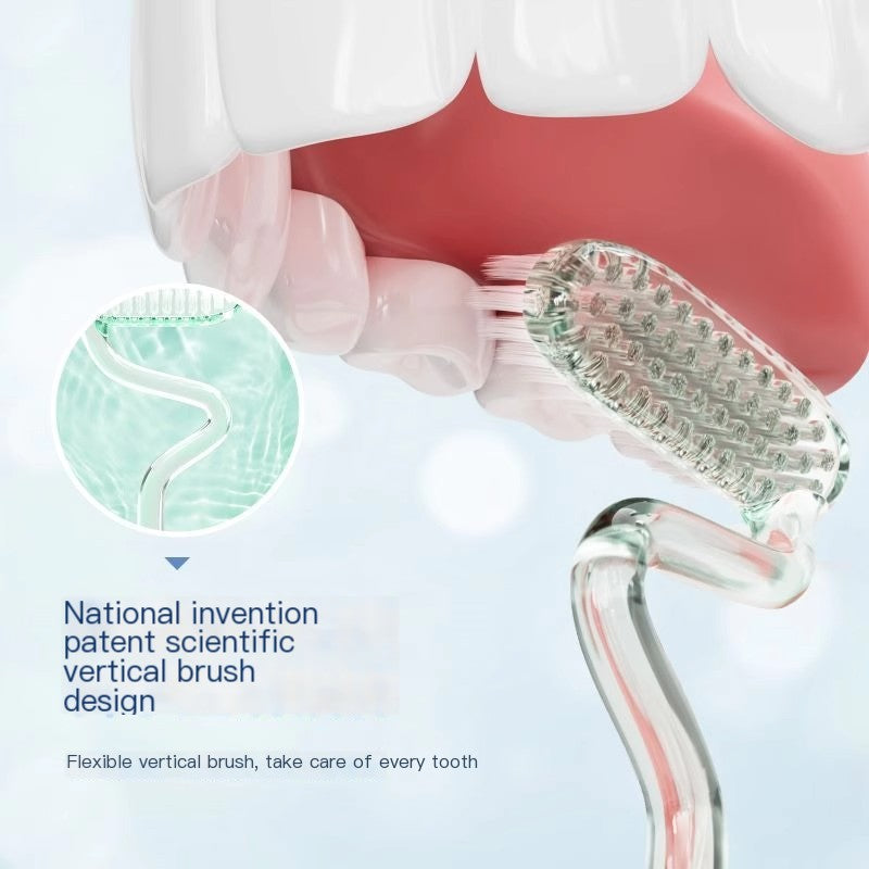 Clear S-Shape soft bristle toothbrush with green bristles in a vertical brushing angle