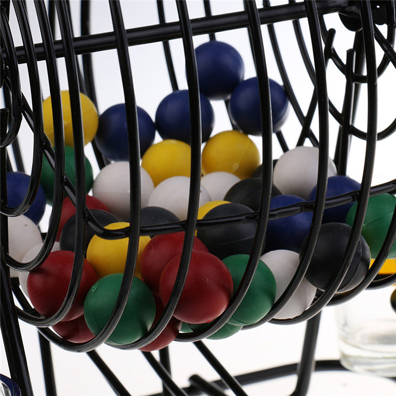 Colored plastic balls inside the black bingo lottery machine cage