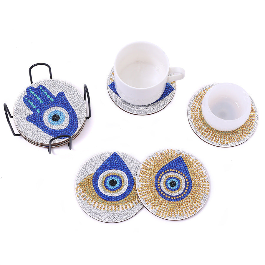 Coffee mugs on blue-and-gold diamond coasters with eye and hamsa motifs