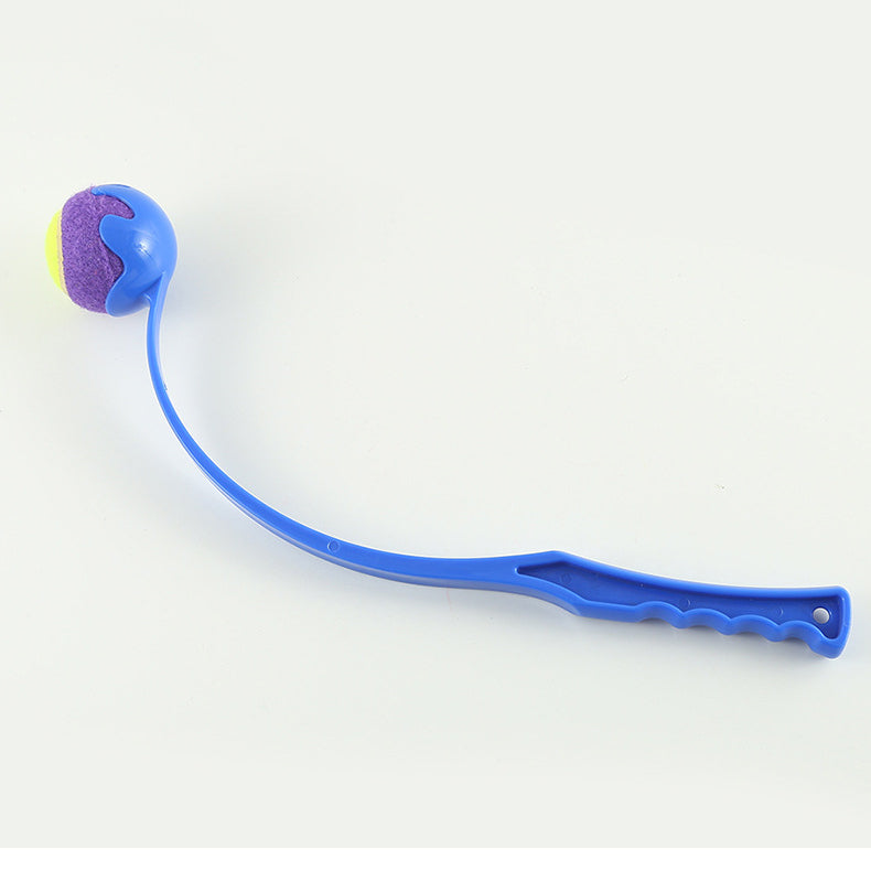 Blue outdoor dog ball launcher with purple ball and green paw-ball accent