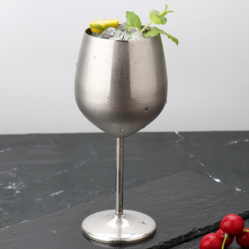 Matt silver wine goblet with water droplets, rounded bowl and tall stem