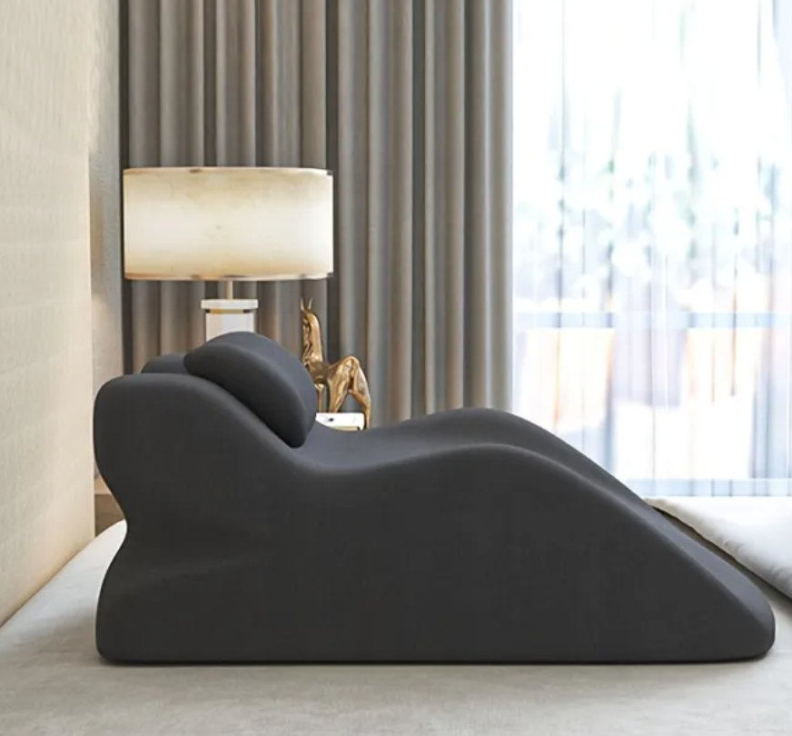 Dark gray stomach sleeper pillow with U-shaped torso support and neck cutout