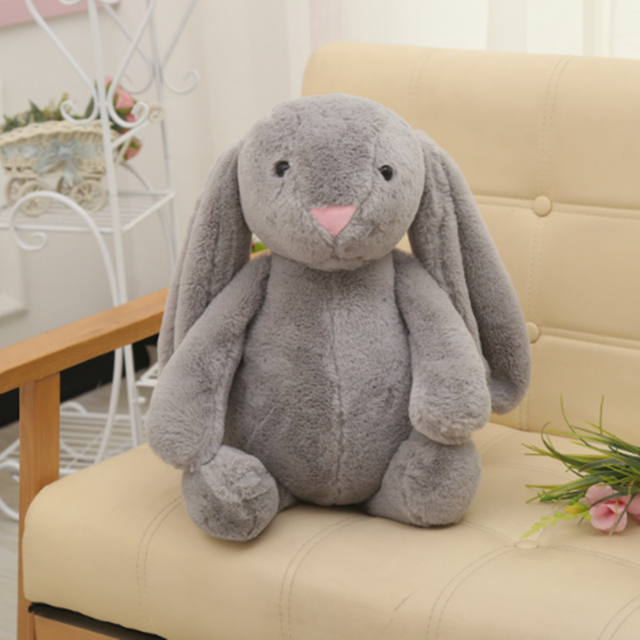 Long-eared bunny plush toy, gray, sitting upright with soft plush face