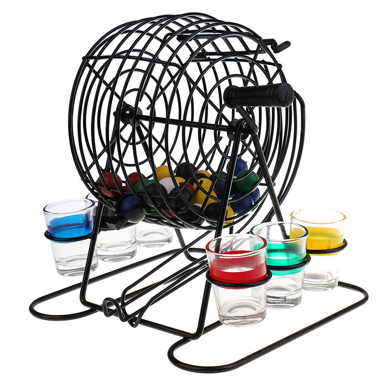Black bingo lottery machine angled view with colored balls inside and shot glasses nearby