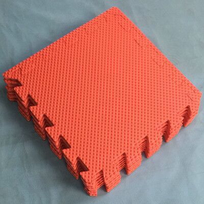 Red kids foam puzzle floor mat, interlocking square panels with raised texture