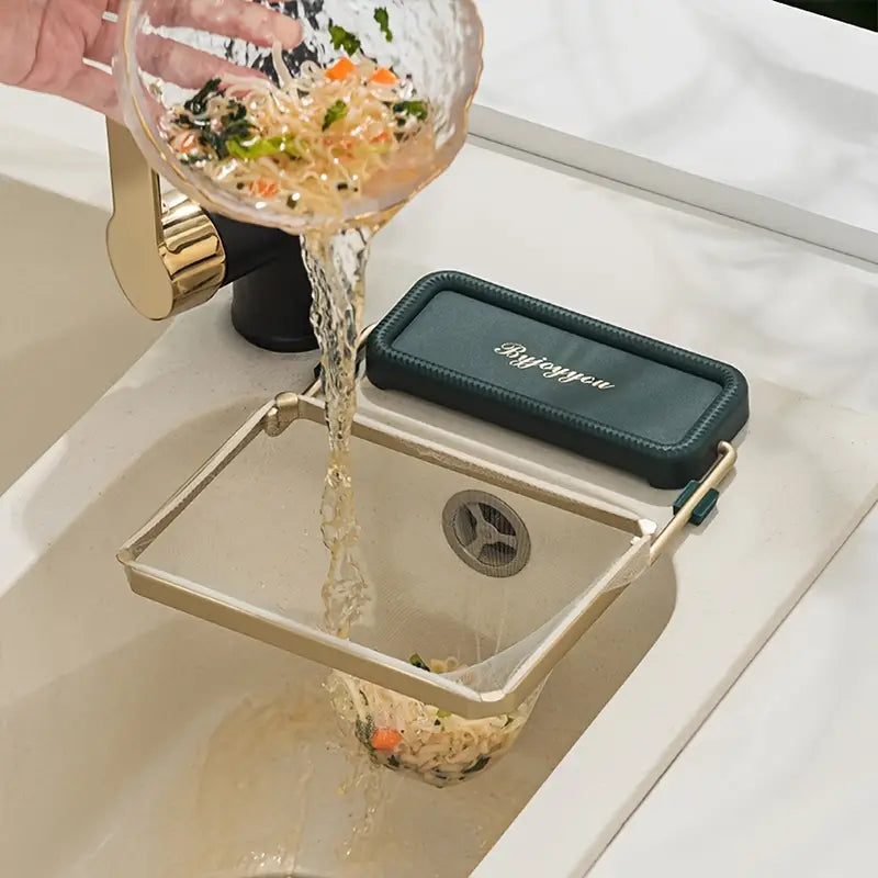 Water pouring into sink strainer rack tray with teal mat and gold frame