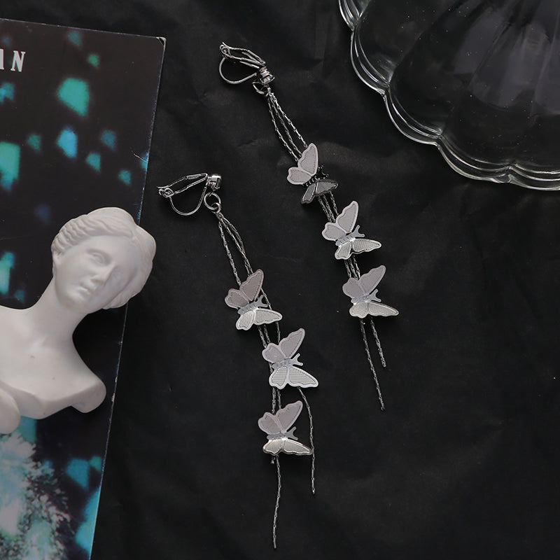 Metal butterfly tassel ear clips, silver-toned with long dangling chains