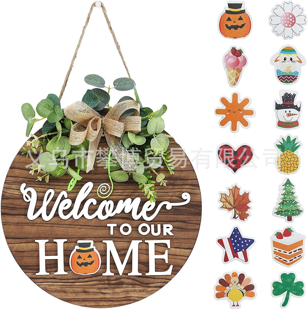 Dunkelbraunes Holz-Willkommensschild mit Eukalyptuskranz und Text „Welcome to our Home“