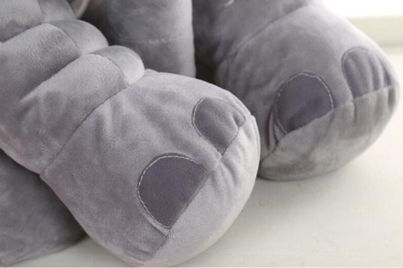 Gray plush elephant toy and pillow companion, close-up of foot and paw details