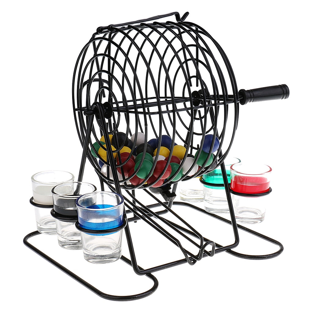 Black bingo lottery game machine with rotating drum and colored balls over shot glasses