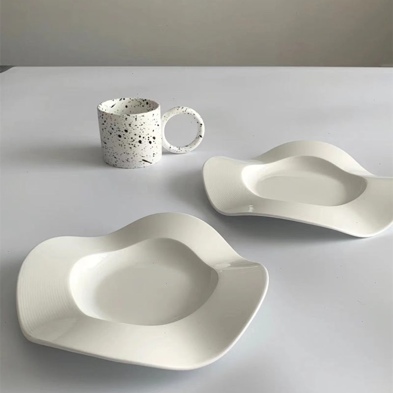 Two white wave side plates with deep oval center wells for snacks or seasoning
