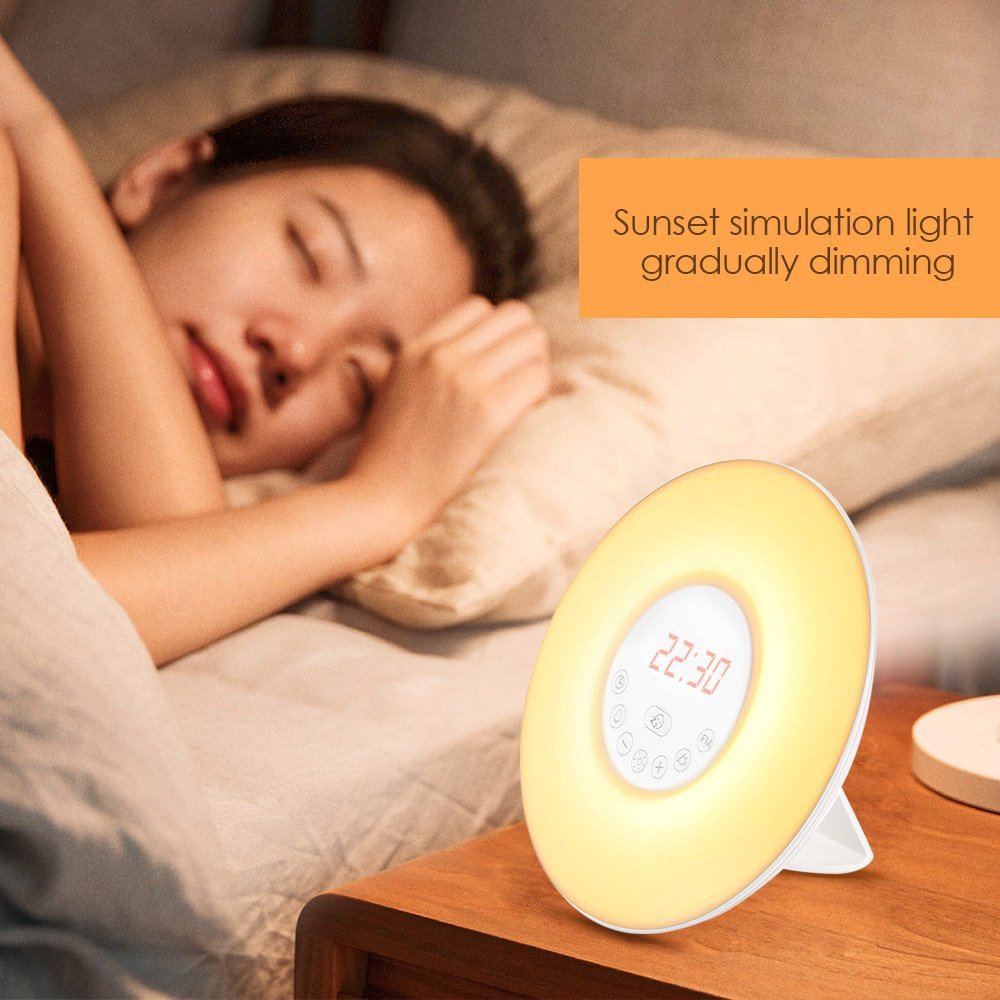 Side table alarm clock radio with yellow glow and red time display 07:30