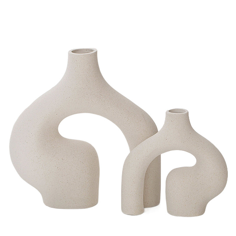 Beige speckled ceramic vases, large and small sculptural shapes with open arch