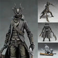 Black hunter action figure in dark coat, mask with antler-like helm, sword at side