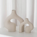 Beige speckled ceramic vase set, two sculptural forms with oval cut-outs