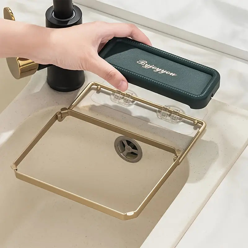 Teal mat sink strainer rack with gold frame and circular drain opening in tray