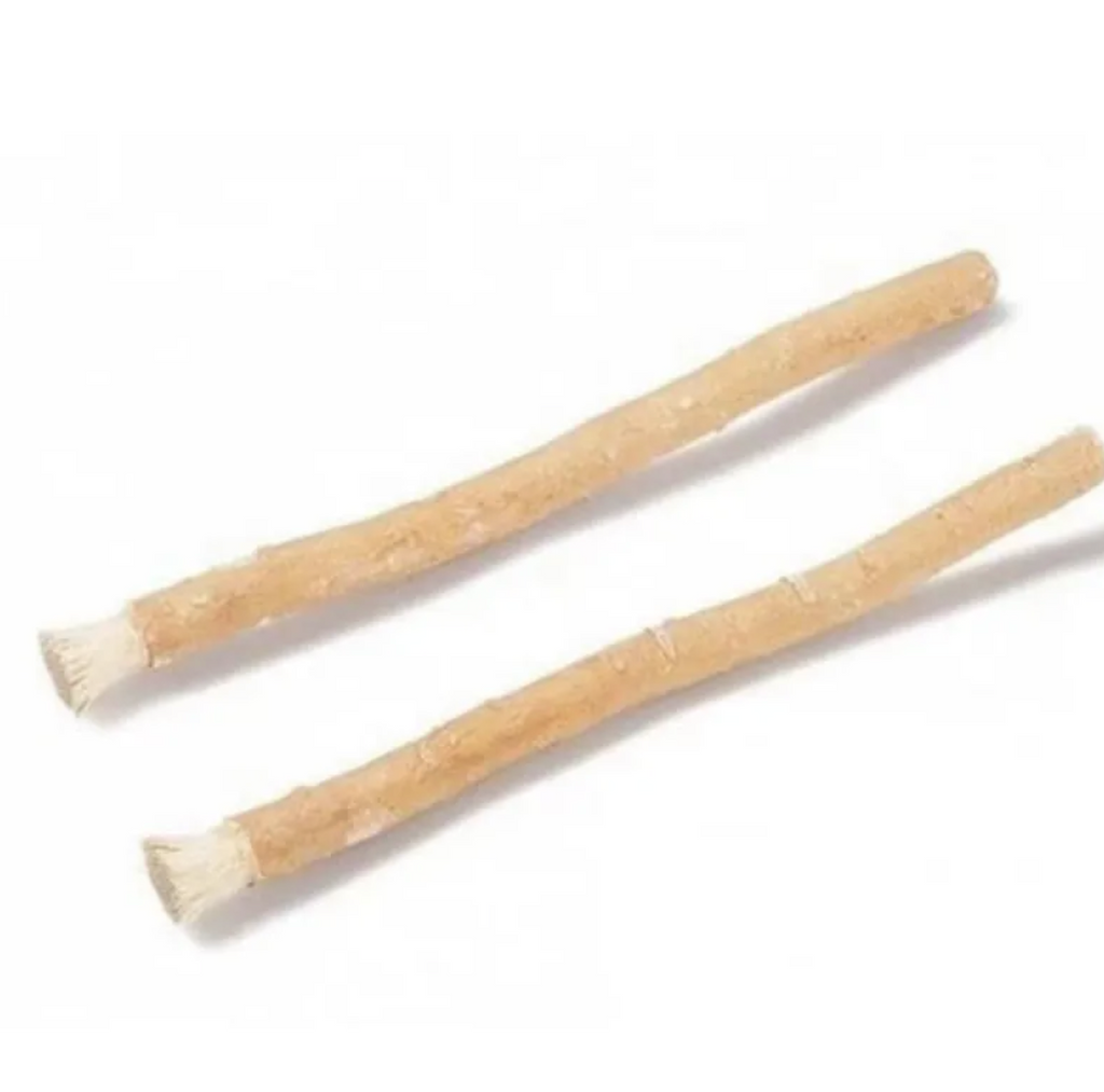 Two natural miswak tooth cleaning sticks with tapered ends.
