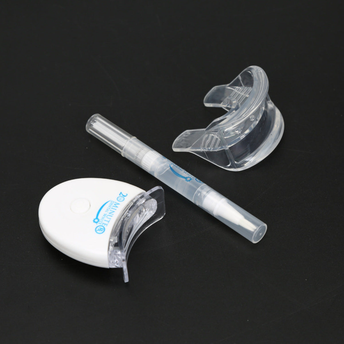 Teeth whitening kit items: clear tray and translucent gel syringe