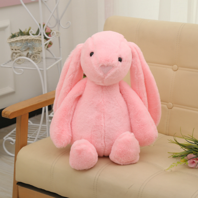 Long-eared bunny plush toy, pink, seated with long floppy ears
