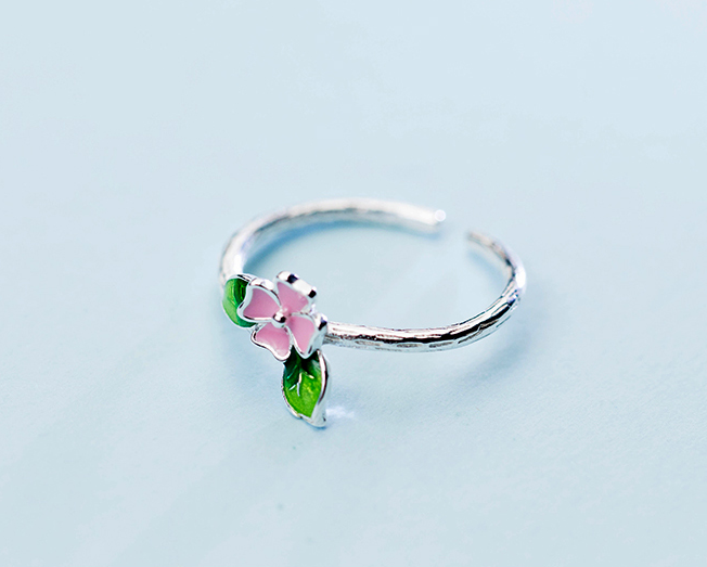 Open silver ring with pink flower centerpiece and three green leaves