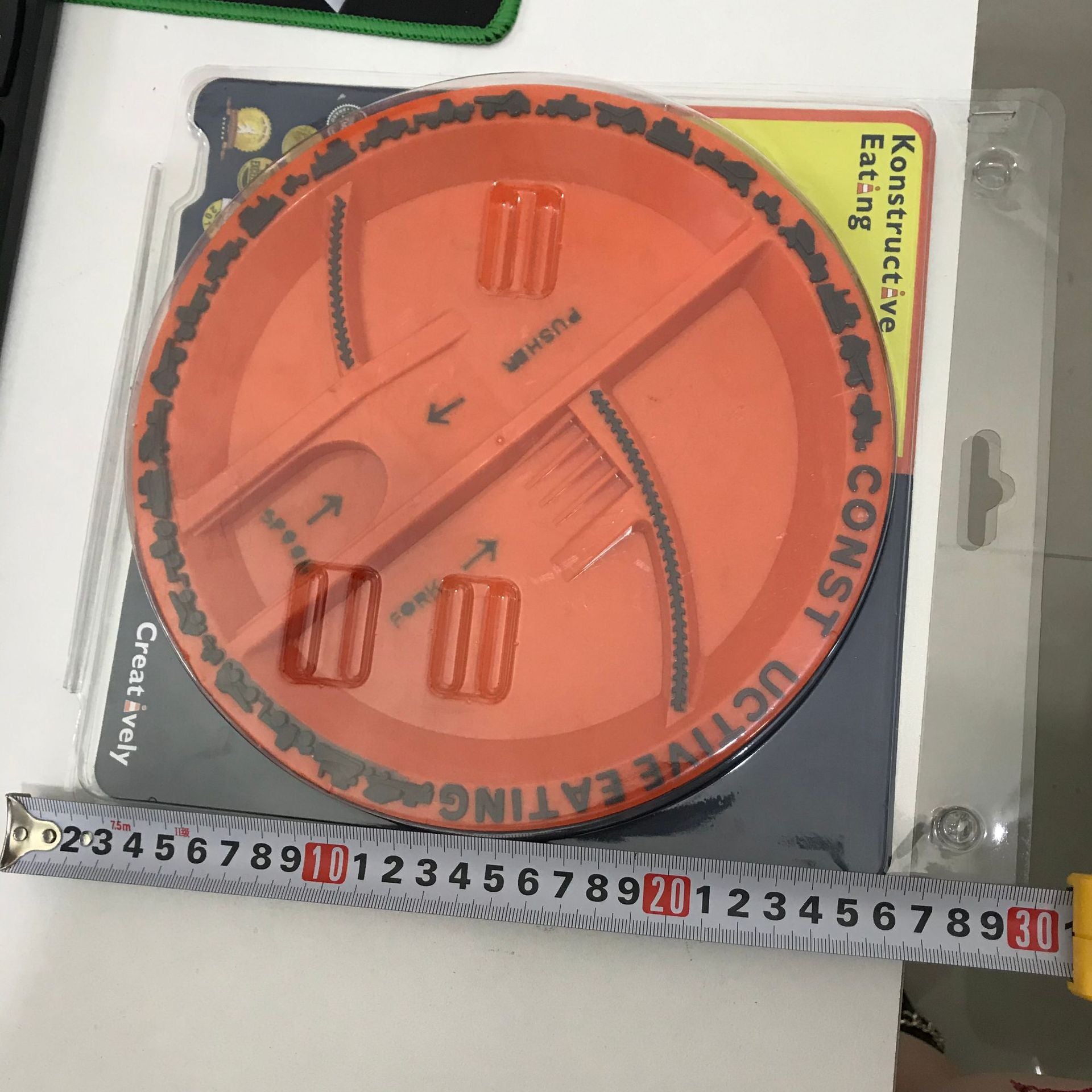 Orange kids construction plate with divided compartments and arrow markings