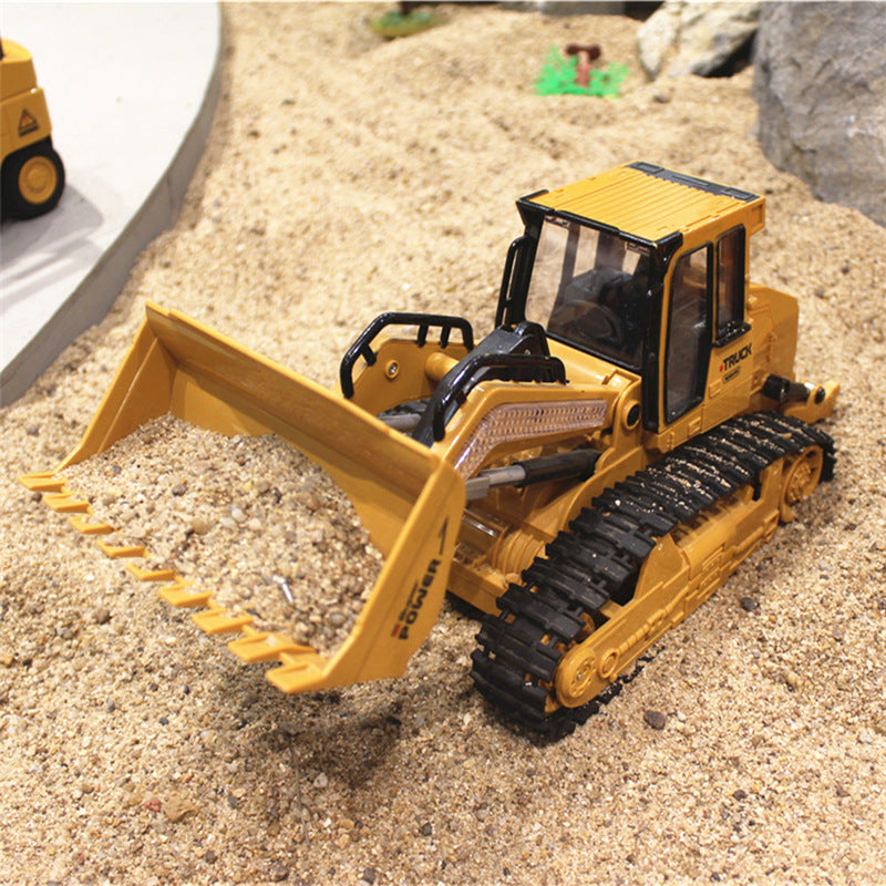 Yellow RC bulldozer excavator toy with large front scoop and tread tracks