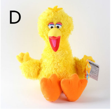 Yellow Elmo plush doll with wide grin, fuzzy fur, orange beak and feet