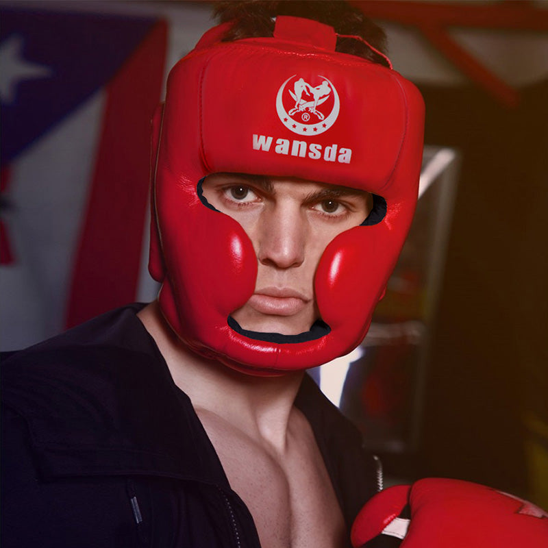 Red headgear with face opening, chin guard, and forehead logo panel