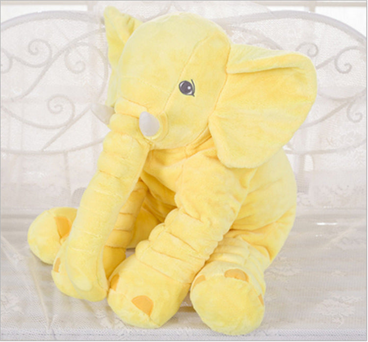 Yellow plush elephant toy and pillow companion, lying down with round belly cushion