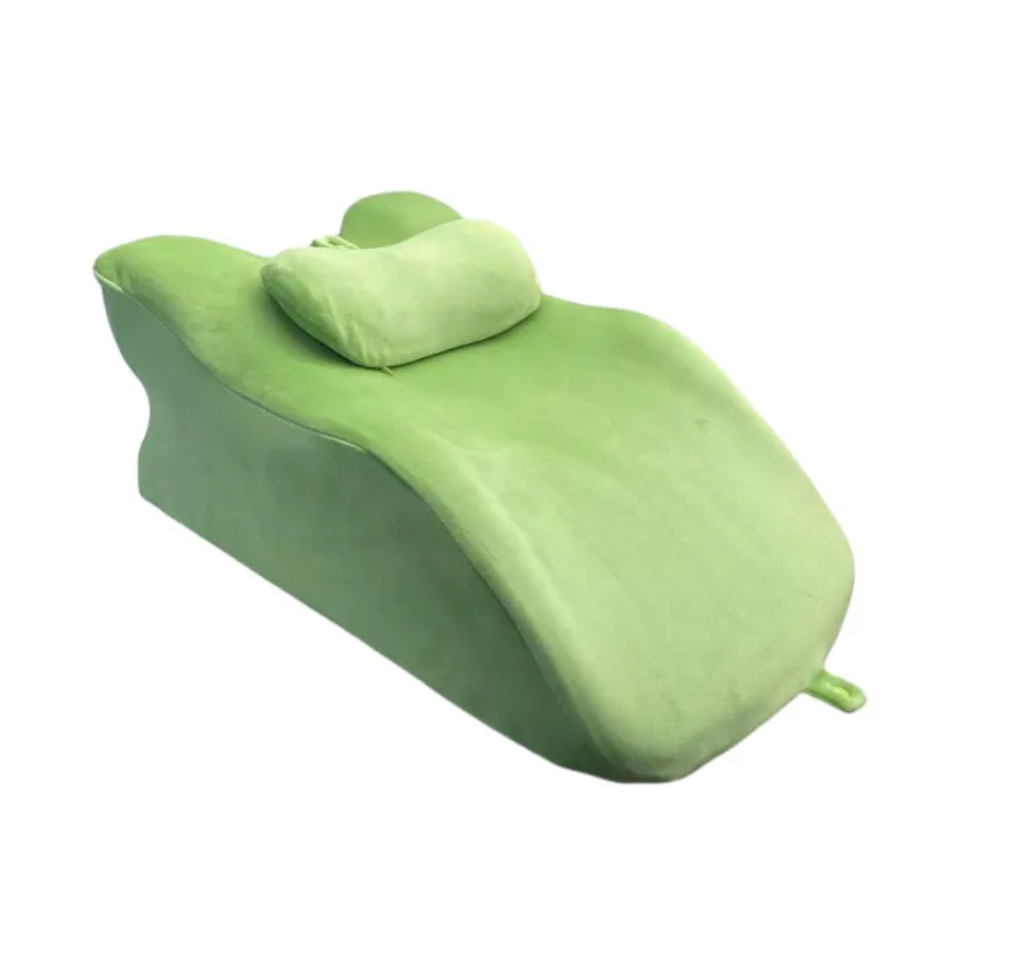 Stomach Sleeper Pillow, green curved bolster with padded headrest and small end tab
