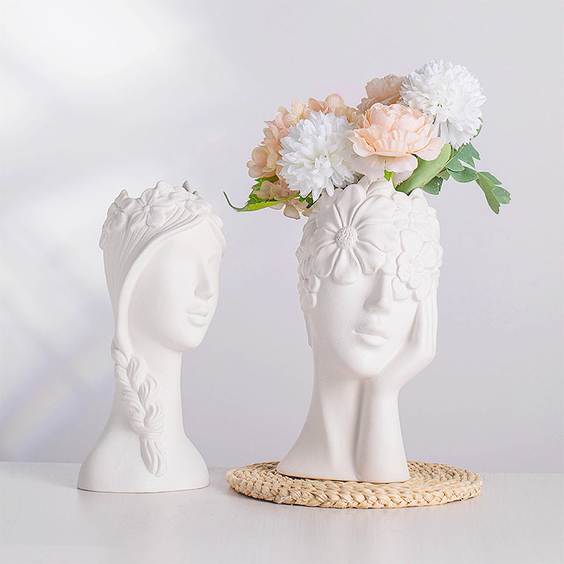 Matte white ceramic head vases with flower relief, styled with pastel bouquet blooms